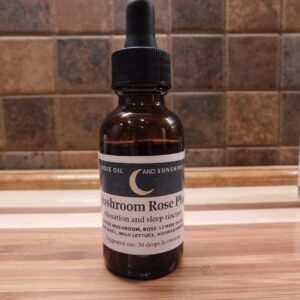 mushroom rose plus relaxation and sleep tincture label with crescent moon, stars, rose oil sunshine banner, and ingredient list on dark blue background